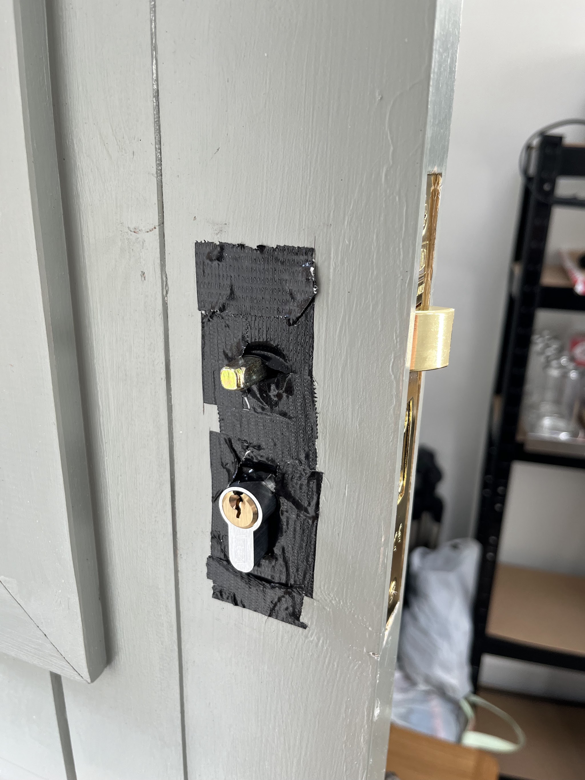 A door lock part way through being replaced, the lock case open in the door edge