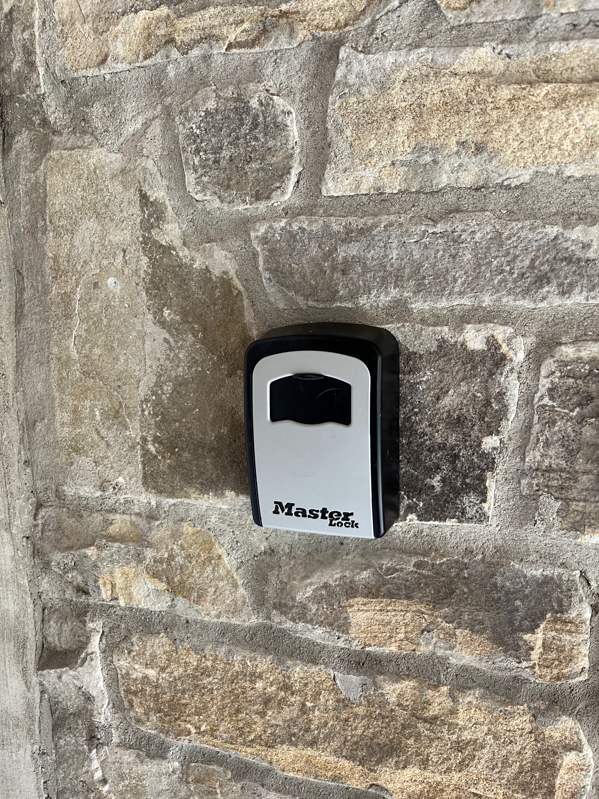 Master Lock key safe fitted to a stone wall